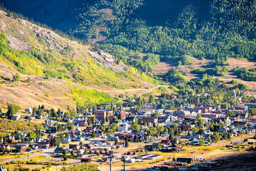 High angle aerial view of Silverton, Colorado small mining town from overlook at summer sunset with...