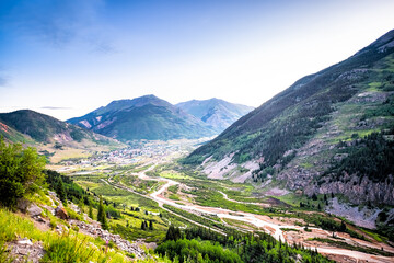 Wide high angle aerial view of Silverton, Colorado small town from overlook at morning sunrise in summer with Mineral creek river, Rocky mountains - obrazy, fototapety, plakaty