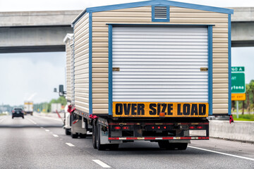 Oversize over size load hauler truck trailer vehicle hauling mobile module home house on North...