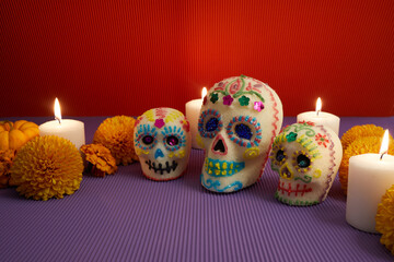Fototapeta na wymiar Dia de los muertos - Day of the dead Sugar skull with candles, and cempasuchil flowers altar decoration.