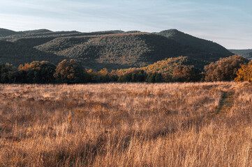 A few hills are bathed in the evening sun.
