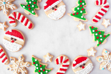 Cute Christmas cookie frame. Top down view on a white marble background with copy space. Holiday...