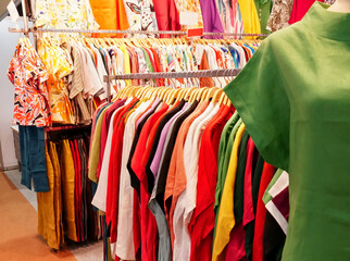 multi-colored shirt, polo shirt , sweater on hangers in a store close-up