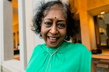 Fototapeta premium An indian elderly dancing and singing at the rooftop