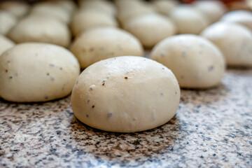 Fototapeta na wymiar fermented dough for pizza. dough ready to prepare. row of doughs ready to ferment. 