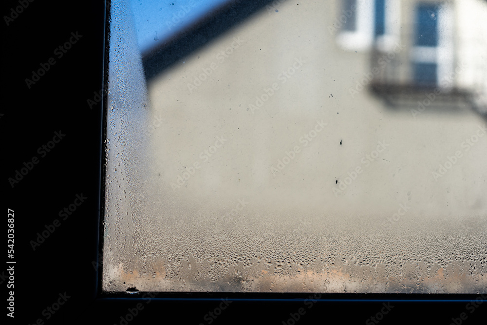 Wall mural Water droplets condensation background of dew on glass, humidity and foggy blank. Outside , bad weather, rain