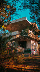 Fototapeta premium Abandoned old building in the park. On the Sunset.