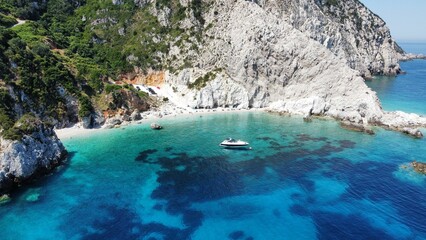 Fototapeta premium Drone shot of a boat near to the Agia Eleni rocky beach in Kefalonia Island, Greece