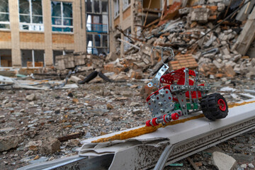 War in Ukraine. 2022 Russian invasion of Ukraine. Children's toy on the background of the destroyed...