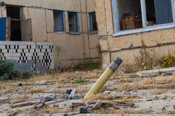 War in Ukraine. 2022 Russian invasion of Ukraine. An unexploded rocket projectile sticks out in the...