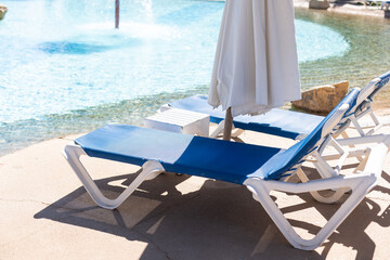 Hotel swimming pool, peaceful, relaxing and surrounded by nature. Clean swimming pool and sunbeds for tourists on holiday.