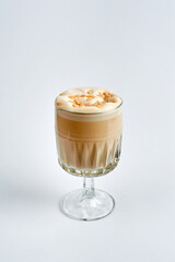 Raf coffee with nuts in a glass, white background
