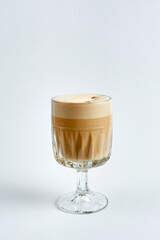 Raf coffee with pistachios in a glass, white background