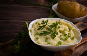 Mashed potatoes on old wooden background