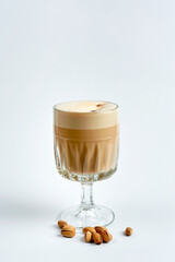 Raf coffee with pistachios in a glass, white background