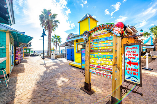 Destin, USA - January 13, 2021: Okaloosa beach city sign for Harbor Boardwalk Pirate's Alley on sunny winter day in Florida panhandle Gulf of mexico