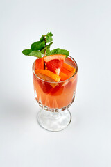 Orange cocktail with grapefruit and mint in a crystal glass