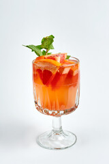 Orange cocktail with grapefruit and mint in a crystal glass