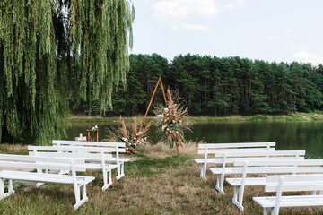 triangular wedding arch with white flowers. High quality photo