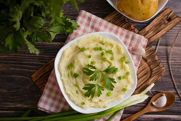 Mashed potatoes on old wooden background