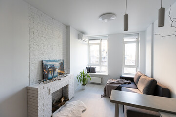 Fototapeta na wymiar studio in minimalist style, fireplace, sofa