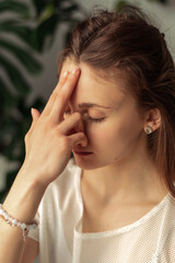 Close-up of young attractive woman practicing breathing yoga,pranayama at home.Relaxation and meditation.Wellness,wellbeing,mental health concept.