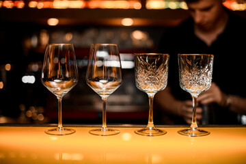 Beautiful empty crystal glasses for wine on bar counter