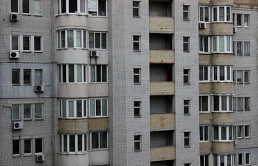 Multi storey modern apartments behind a high-rise building made of old silicone bricks
