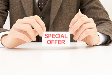 businessman presenting 'SPECIAL OFFER' word on white card