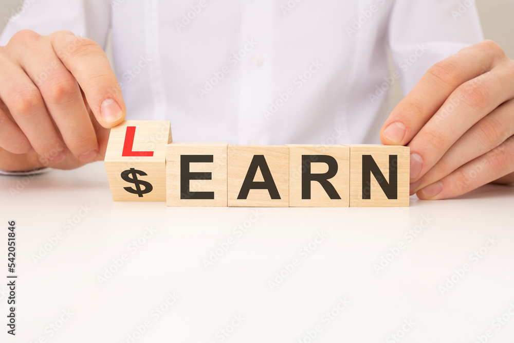 Poster learn or earn symbol. turned a cube and changed the word 'earn' to 'learn'. white background. busine