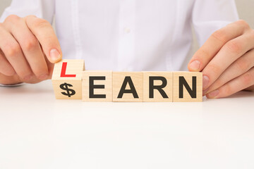 learn or earn symbol. turned a cube and changed the word 'earn' to 'learn'. white background. business and learn or earn concept