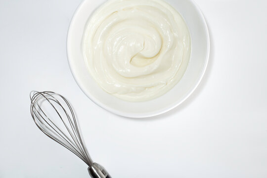 Whipped Cream And Whisk On White Background