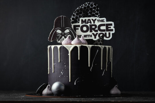 Kyiv, Ukraine - October 11: Star Wars cake with black cream cheese frosting and white chocolate drips decorated with edible  Darth Vader head silhouette and "May the force be with you" text