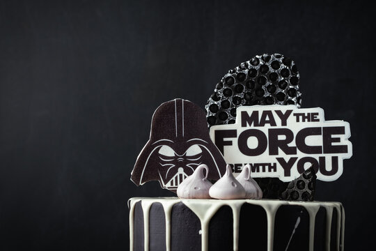 Kyiv, Ukraine - October 11: Star Wars cake with black cream cheese frosting and white chocolate drips decorated with edible  Darth Vader head silhouette and "May the force be with you" text