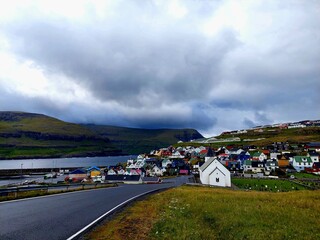 View of Eiði, a small coastal village characterized by its very colorful houses, located in the...