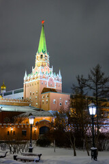 Fototapeta premium Spasskaya tower and winter Kremlin against the backdrop of street Christmas decorations.