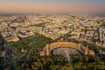 Fototapeta na wymiar The drone aerial view of Spain Square (Plaza de Espana) in Seville (Sevilla) city, Andalusia, Spain. The Plaza is a landmark example mixing elements of the Baroque Revival, Renaissance Revival and Mo