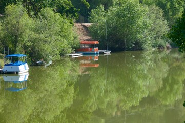 Small boats floating lazily on reflective Malibu Lake