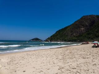 View of Prainha Beach, a paradise in the west side of Rio de Janeiro, Brazil. Big hills around. Sunny day