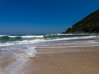 View of Prainha Beach, a paradise in the west side of Rio de Janeiro, Brazil. Big hills around. Sunny day