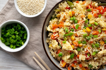 Homemade Cauliflower Fried Rice with Chives and Sesame Seeds in a Bowl, top view. Flat lay, overhead, from above.