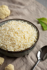 Organic Raw Cauliflower Rice in a Bowl, side view.