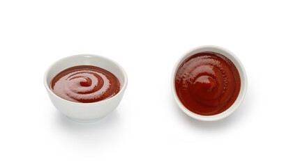 Red ketchup or tomato sauce in a white little bowl, gravy boat isolated on white background with clipping path, cut out.