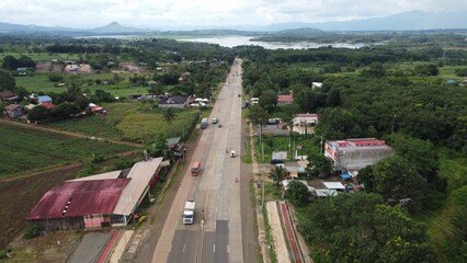 Beautiful view of a traffic road with green trees and houses