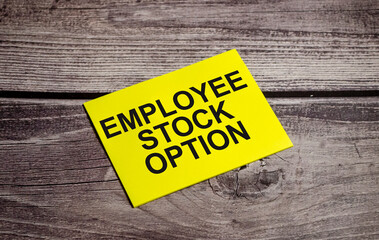 Employee Stock Option word on yellow sticker and wooden background