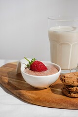 Vertical shot of strawberry dessert with milk and cookies
