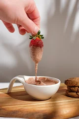Fotobehang Vertical shot of strawberry dessert with cookies © Nuri Sarialioglu/Wirestock Creators