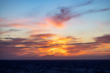 Obraz premium Dramatic Colorful Sunset Sky over North Atlantic Ocean. Cloudscape Nature Background.
