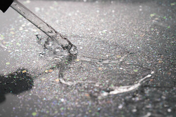 Gradient. Backlit. Pipette with serum or gel on a black background with sequins. Hydrating hyaluronic acid. Antibacterial gel. Cosmetology. Water.