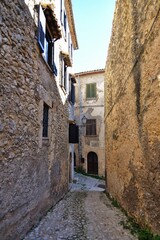 Fototapeta na wymiar A narrow street between the old stone houses of Civitavecchia di Arpino, a medieval village in the Lazio region, Italy.